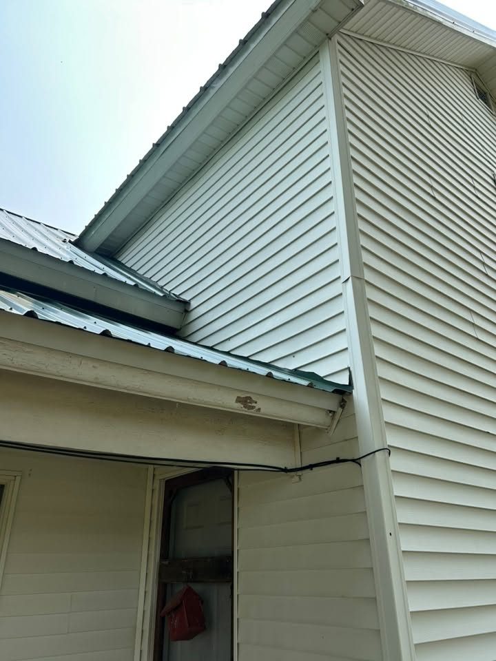 The same gable end siding and soffit cleaned back to its original colour