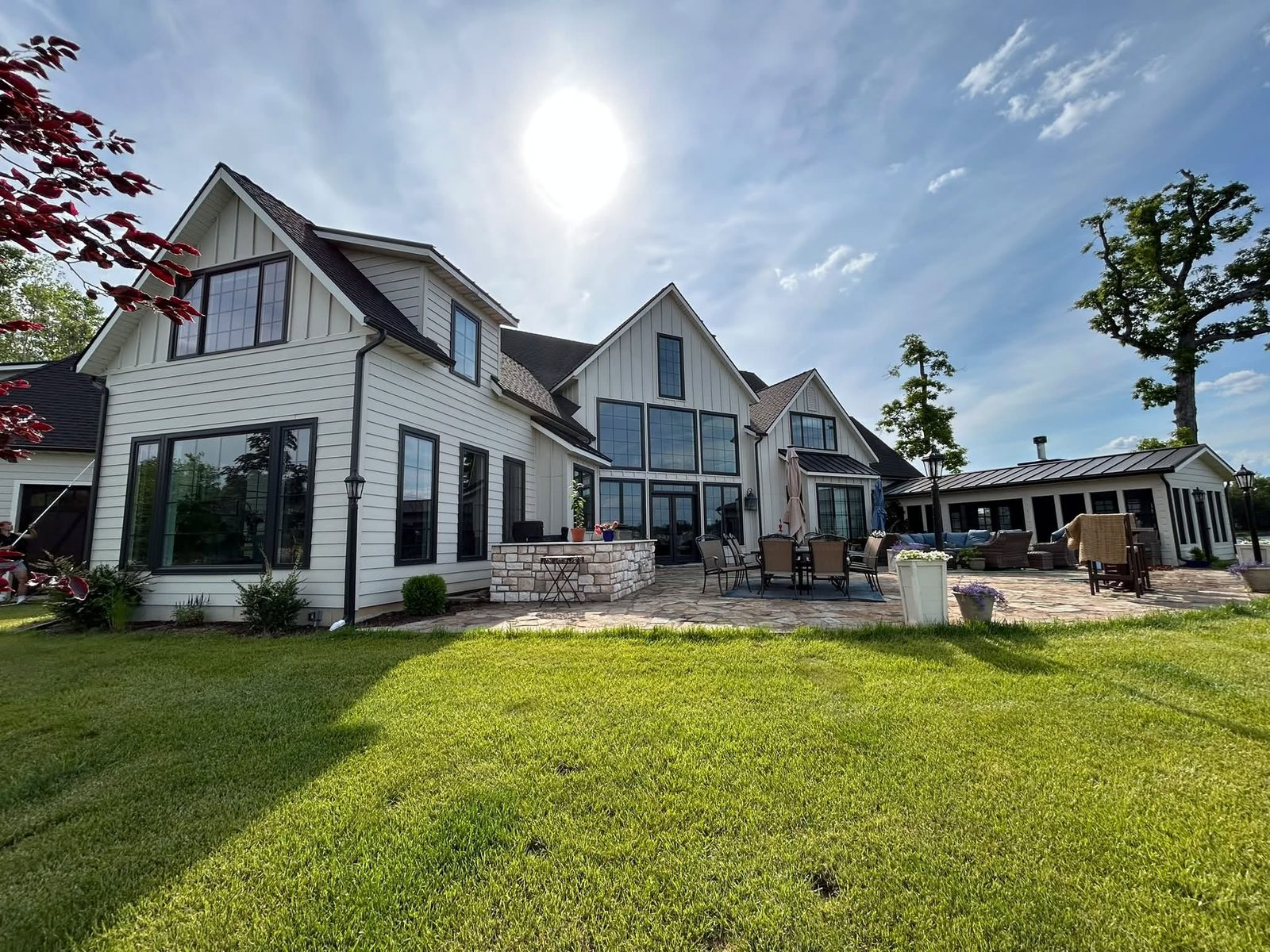 White modern farmhouse with clean siding and large windows after an exterior clean